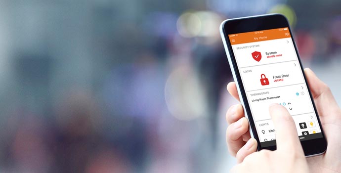 Person using the Alarm.com security app on a phone